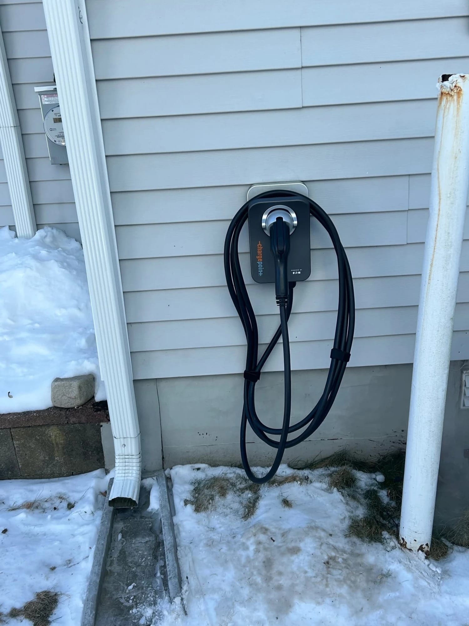 ChargePoint home EV charger mounted on house siding