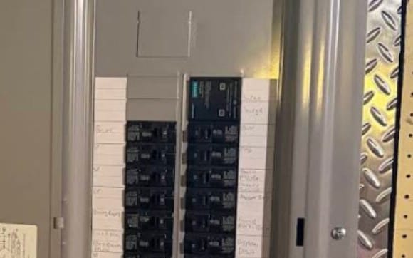 Breaker panel with a plug-in surge protective device at the top of the breaker column